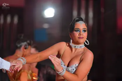 Dancesport competitor: Female dancer: silver/white sequined/crystal-encrusted Latin dance top with thin