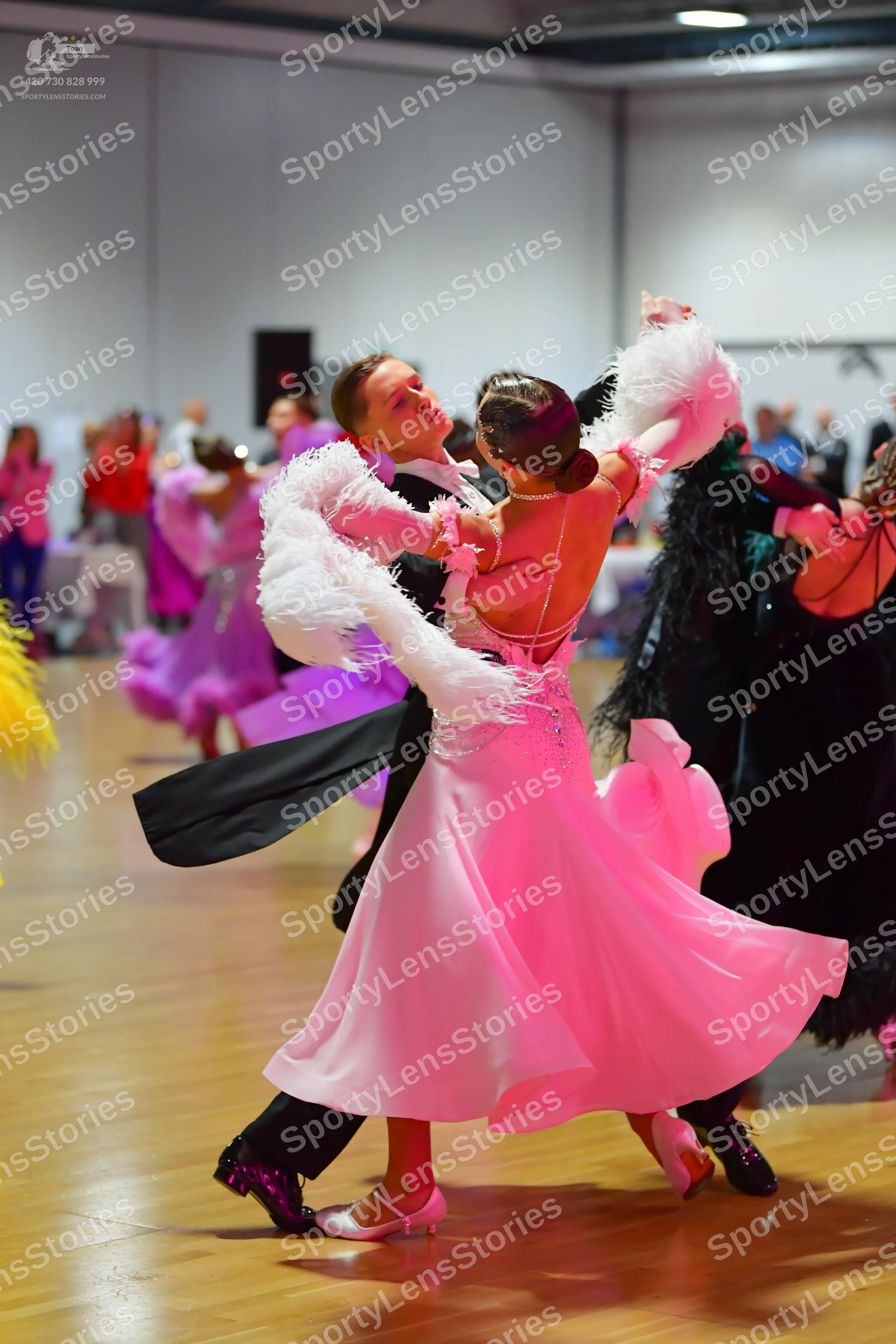 Dancesport competitor: Main female dancer: light pink/blush ballgown with a voluminous, flowing skirt a