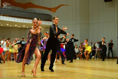 Dancesport competitor: Main female dancer: dark latin dress with multi-colored sequins (purple, blue, p