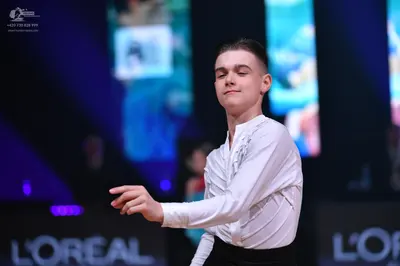 Dancesport competitor: Male dancer: white long-sleeve textured shirt and black trousers