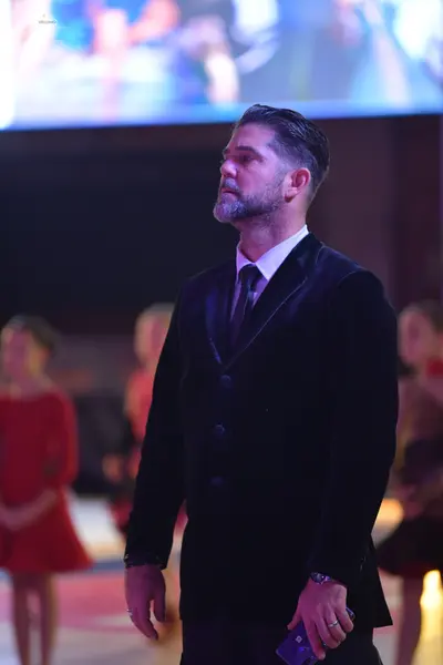 Dancesport competitor: ** Male: Black tailsuit with sequin lapels