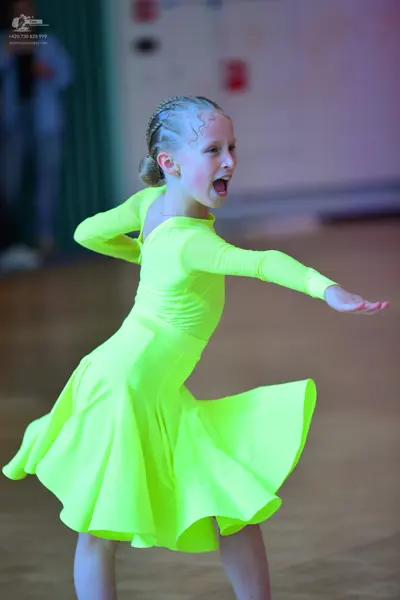 Dancesport competitor: Female dancer: neon yellow long-sleeved latin dress