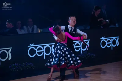 Dancesport competitor: Male dancer: white shirt, black waistcoat, black necktie, and black trousers