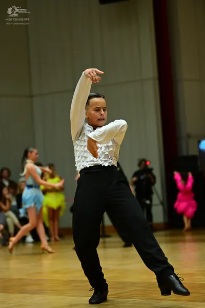 Dancesport competitor: Male dancer: white long-sleeve shirt with ruffles on the front and black trouser
