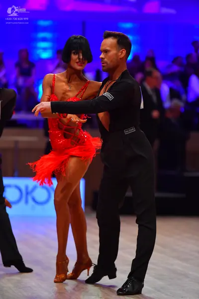 Dancesport competitor: Male dancer: black long-sleeved shirt and black trousers