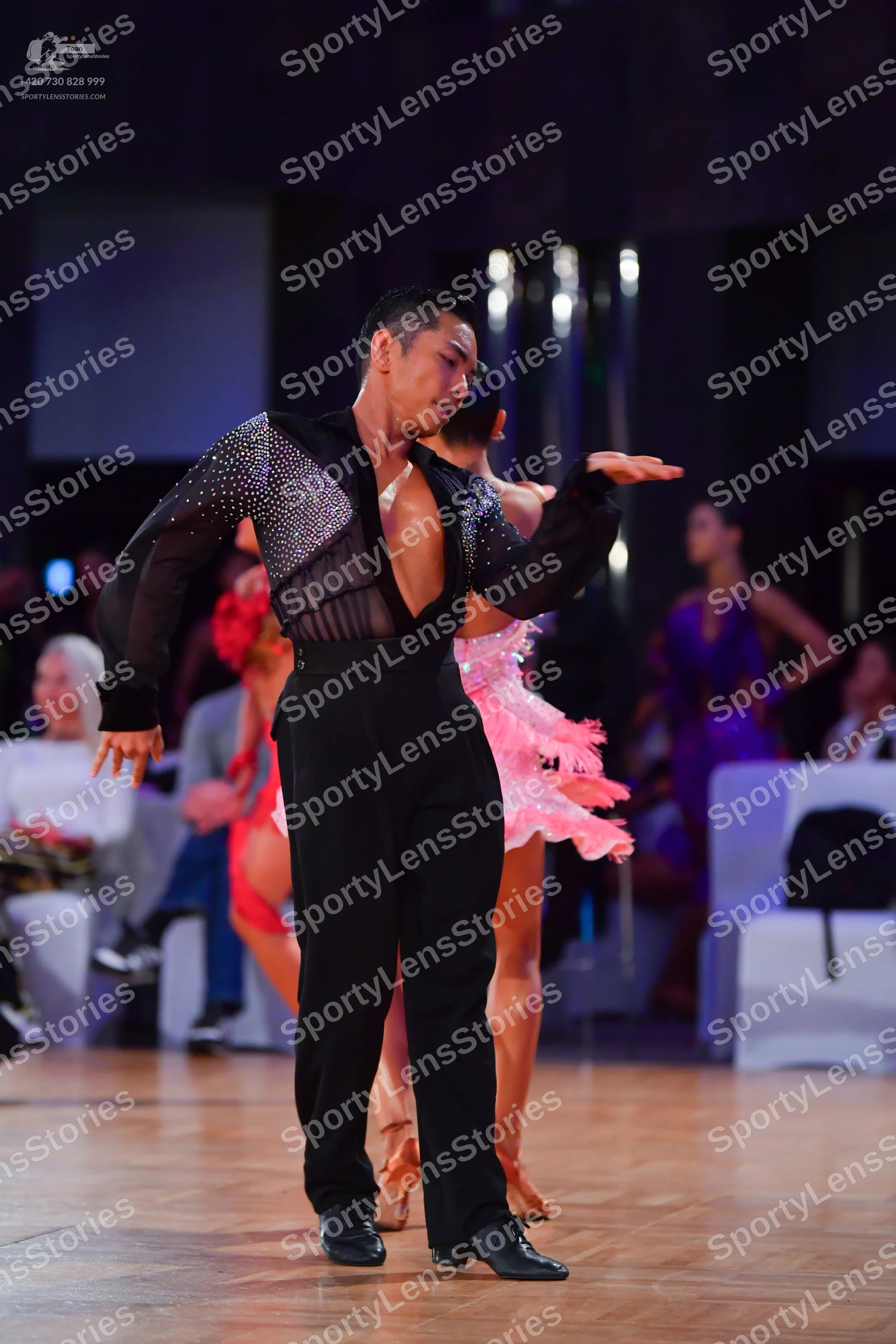 Dancesport competitor: Male dancer: black long-sleeved shirt with a sheer, sequined chest panel and bla