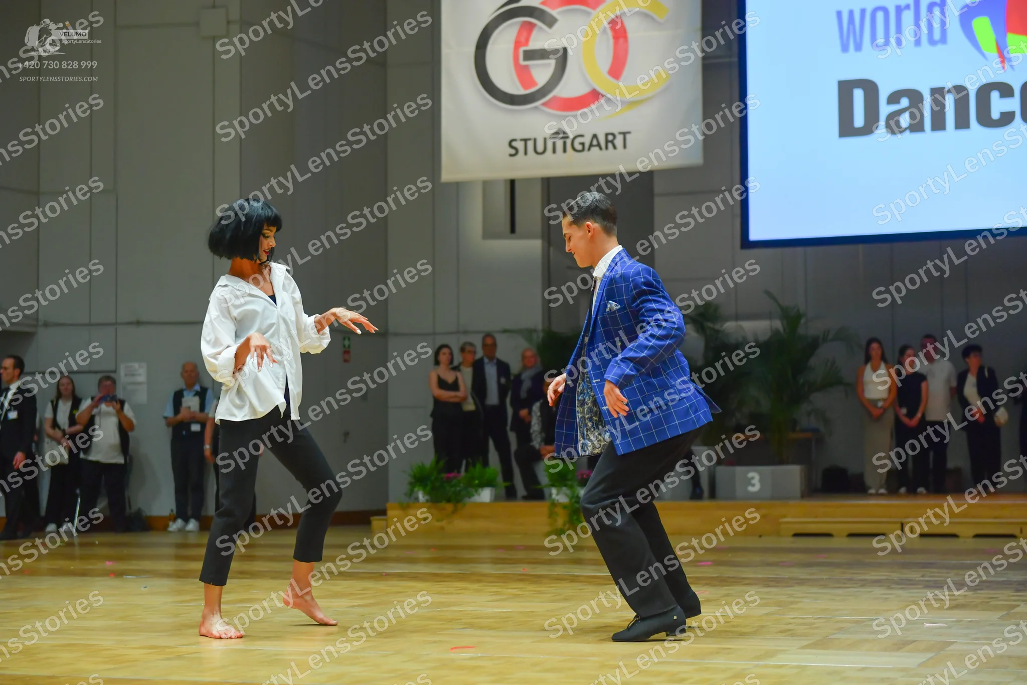 Dancesport competitor: Male dancer: blue patterned suit jacket with black trousers and black dance shoe