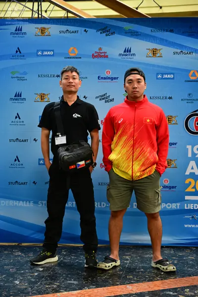 Dancesport competitor: Man on the left: black polo shirt and black pants