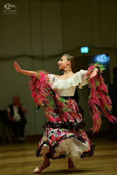 Dancesport competitor: ** Red Latin dress
*   **Color:** Predominantly red, with black and white polka 
