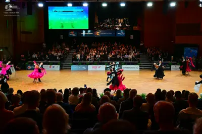 Dancesport competitor: Female dancer: bright pink latin dress