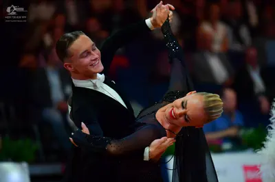 Dancesport competitor: Male dancer: black suit, white shirt, and white bowtie