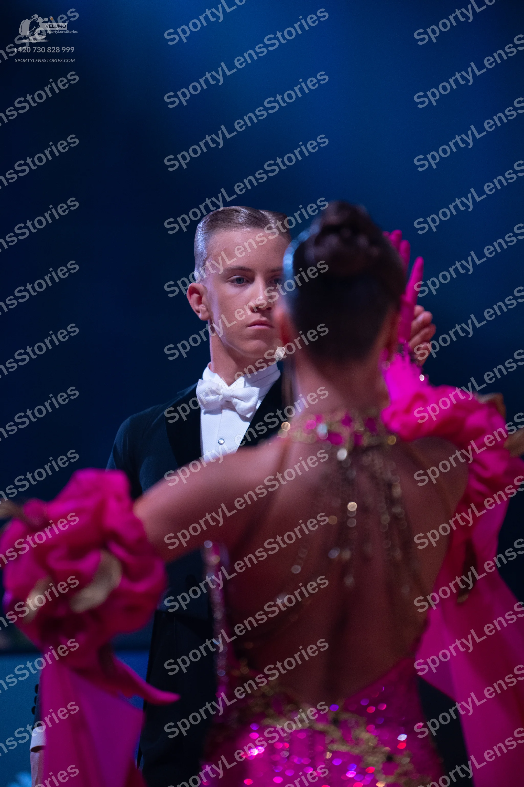 Dancesport competitor: Male dancer: black suit with a white shirt and white bow tie