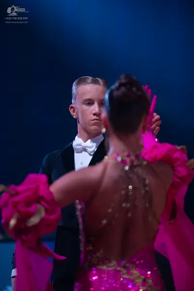 Dancesport competitor: Male dancer: black suit with a white shirt and white bow tie