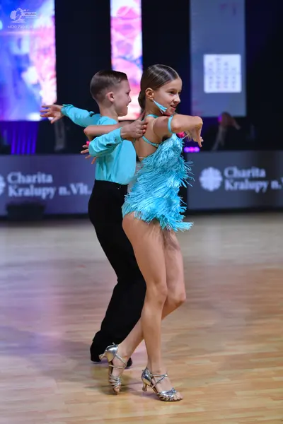 Dancesport competitor: Male dancer: light blue long-sleeved shirt and black trousers