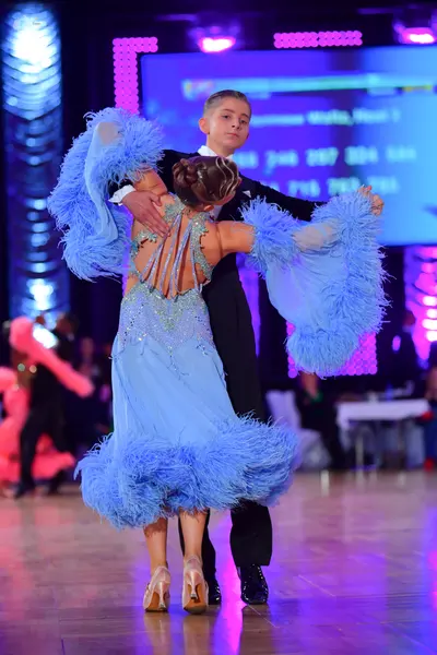 Dancesport competitor: Male dancer: black suit with a white shirt and black bow tie
