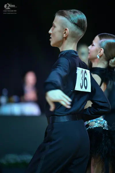 Dancesport competitor: Male dancer: black long-sleeve shirt and black trousers