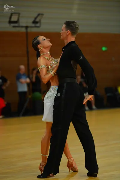 Dancesport competitor: Male dancer: black long-sleeved shirt and black trousers