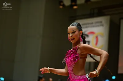 Dancesport competitor #178: Female dancer: pink sequined latin costume with cutouts, large pink hoop earring