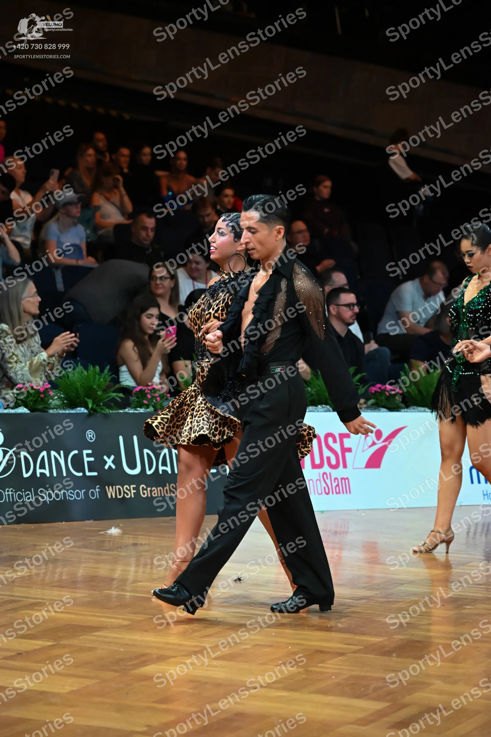 Dancesport competitor: Male dancer: black long-sleeved Latin dance shirt with textured/sequined shoulde