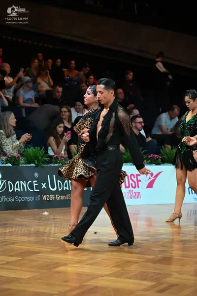 Dancesport competitor: Male dancer: black long-sleeved Latin dance shirt with textured/sequined shoulde