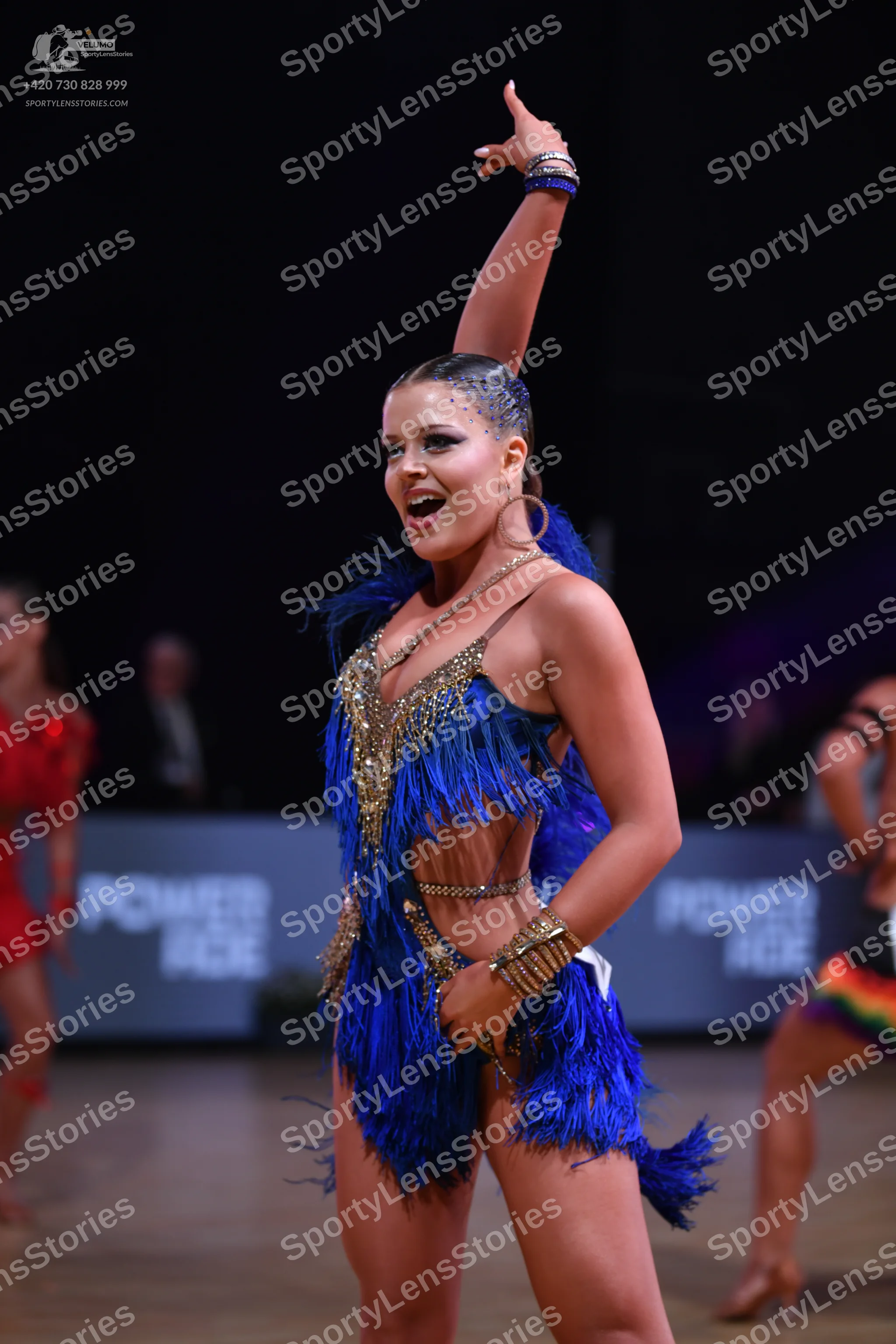 Dancesport competitor: Main female dancer: royal blue Latin dance costume with blue feather fringe and