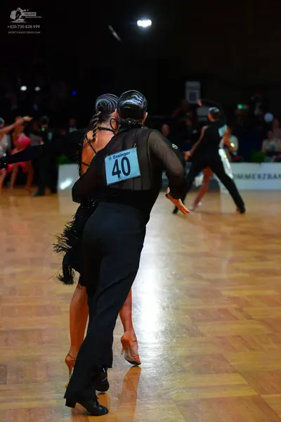 Dancesport competitor #40: Male dancer: black trousers and a black shirt with a sheer mesh back