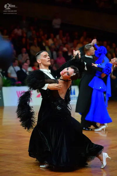 Dancesport competitor: Male dancer: black suit with white shirt and black bowtie