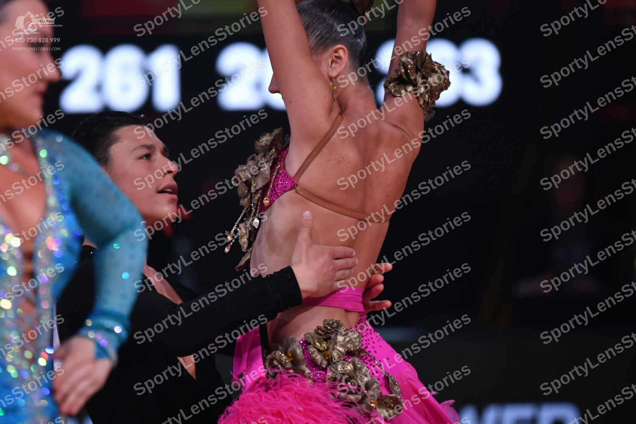 Dancesport competitor: Female dancer: light blue/cyan Latin dress with sequins and mesh
