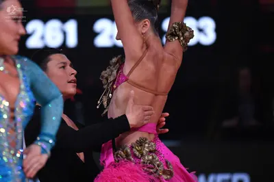Dancesport competitor: Female dancer: light blue/cyan Latin dress with sequins and mesh