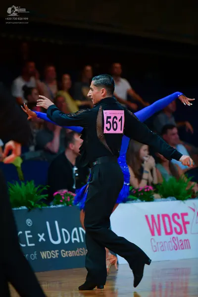 Dancesport competitor: Male dancer: black long-sleeved shirt with textured/sequined detail on the back 