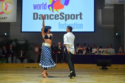 Dancesport competitor: Male dancer: white long-sleeved shirt and black trousers