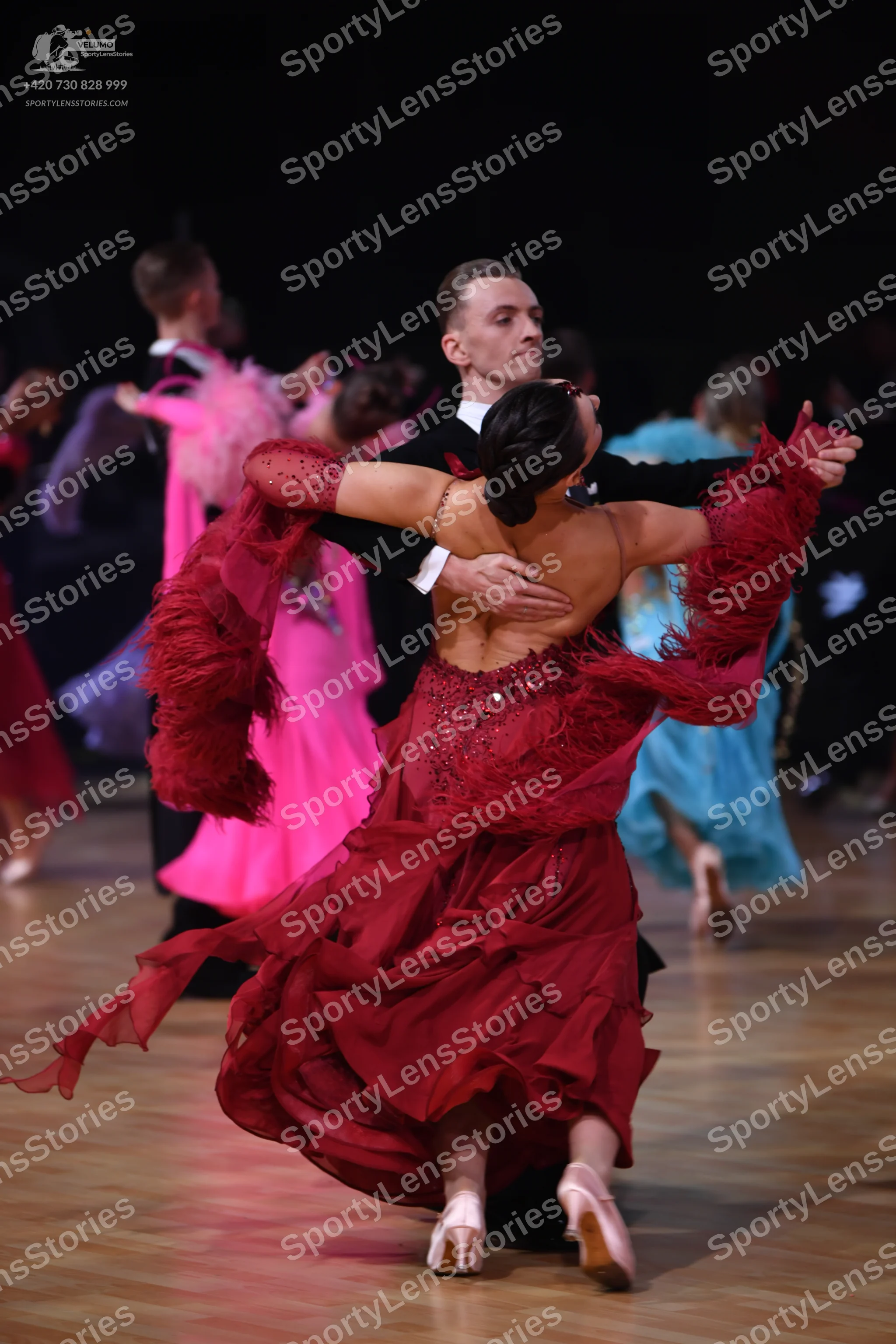 Dancesport competitor: Male dancer: black suit with a white shirt cuff visible