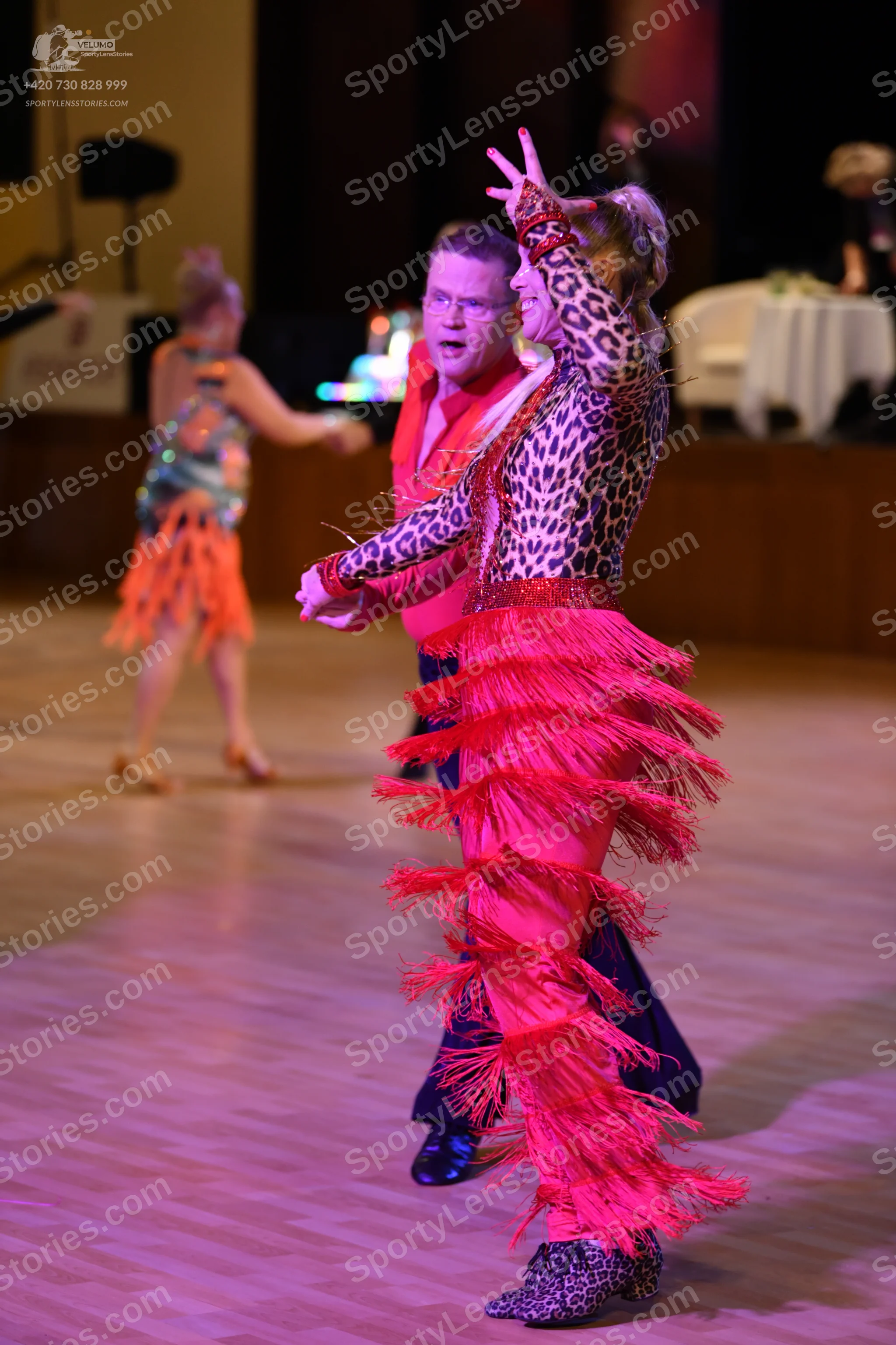 Dancesport competitor: ** Black satin suit with white sequin lapels