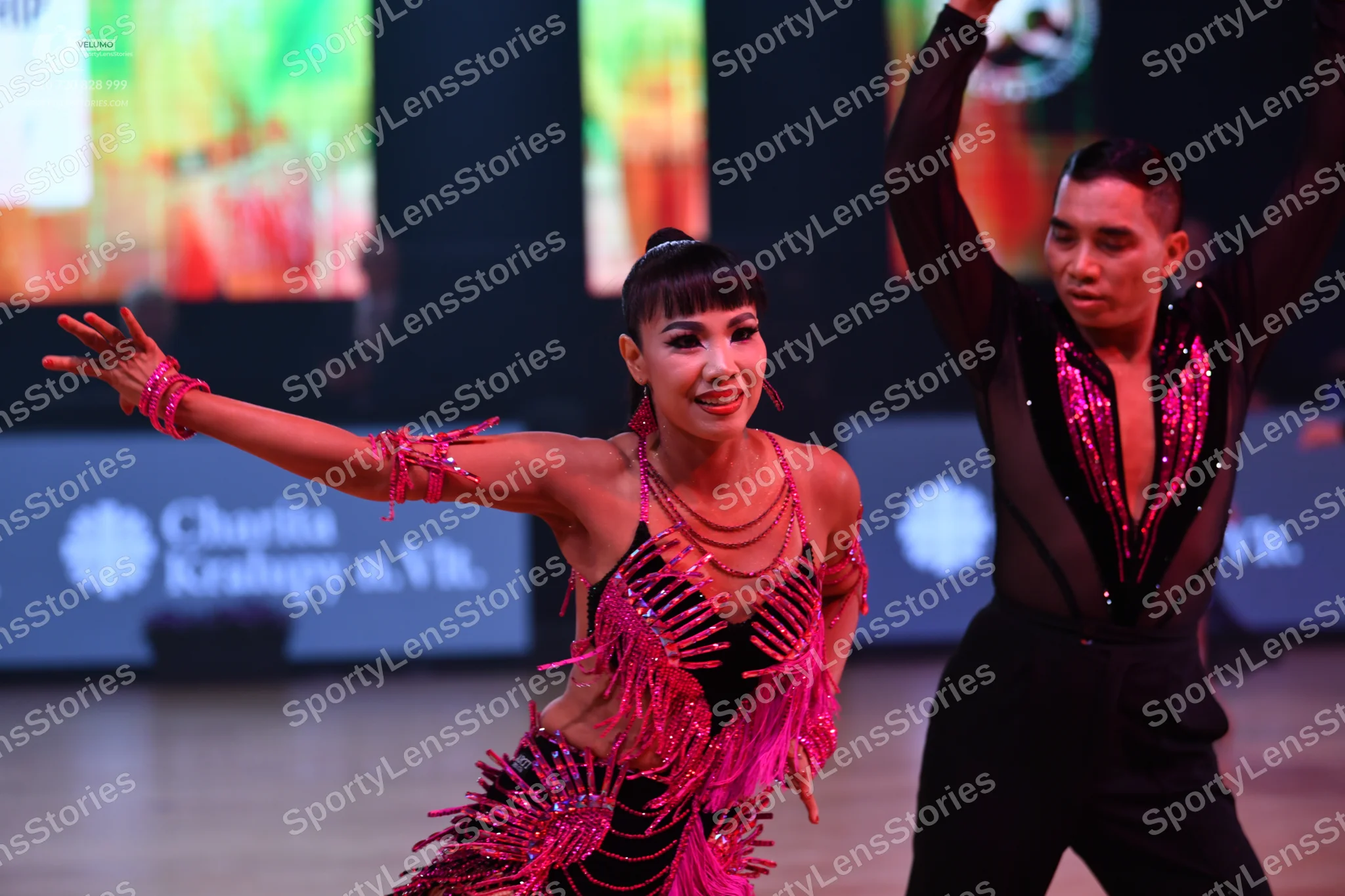 Dancesport competitor: Female dancer: pink/magenta latin dress with sequins and fringe