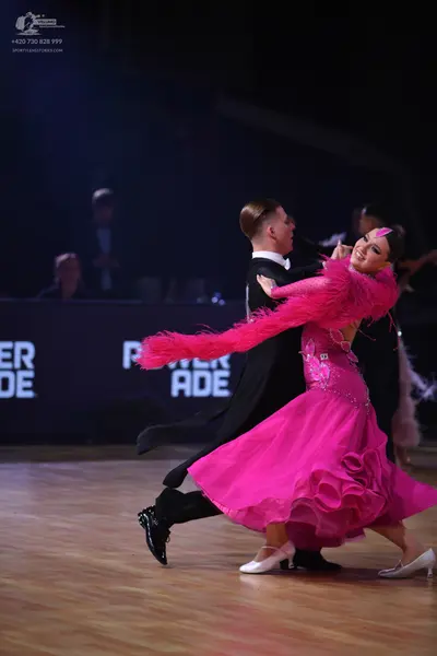 Dancesport competitor: Male dancer: black ballroom suit with black trousers and black dance shoes