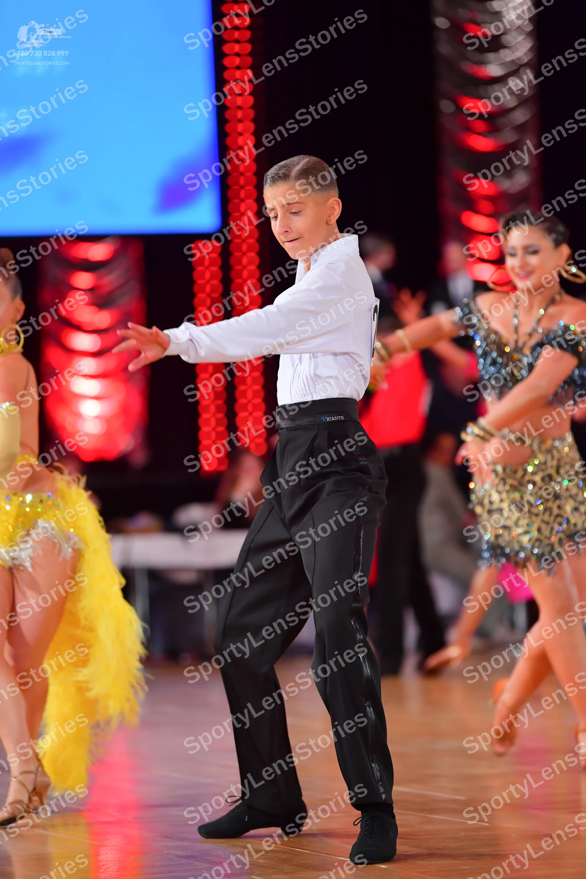 Dancesport competitor: Male dancer: white long-sleeved shirt and black trousers with a satin side strip