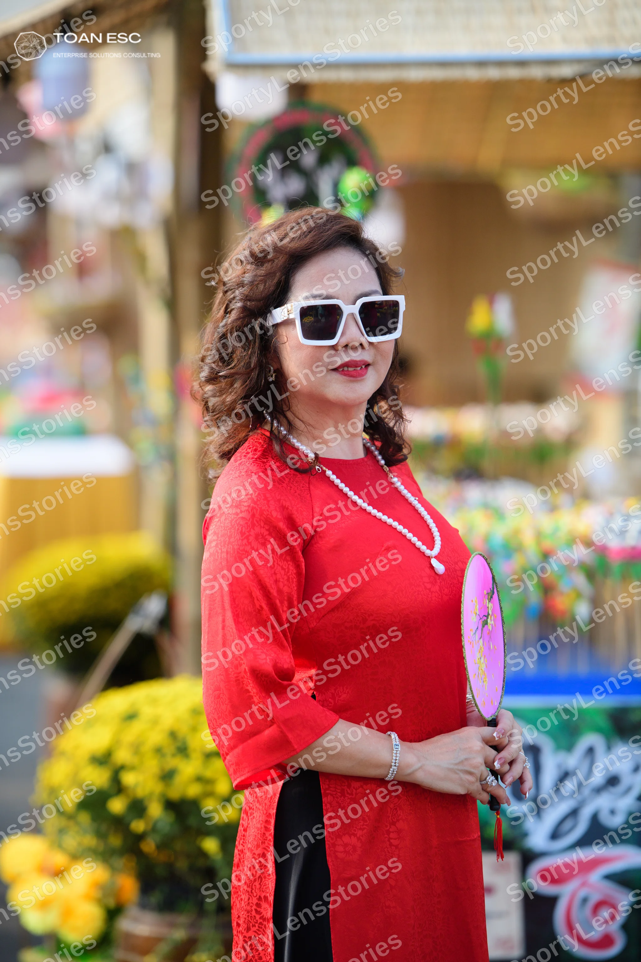 Dancesport competitor: Female dancer: red long-sleeved dress with a black panel at the bottom, wearing 