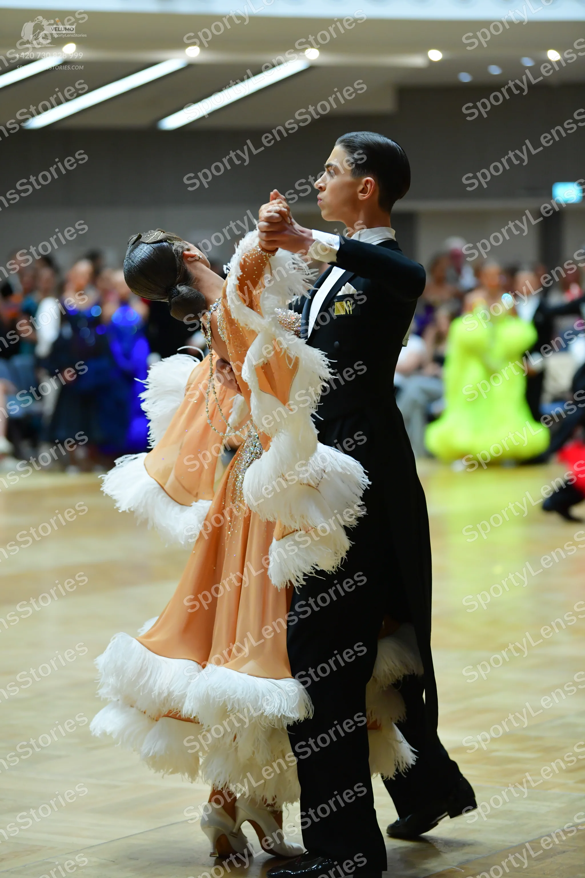 Dancesport competitor: Male dancer: black suit with a white shirt and white bow tie
