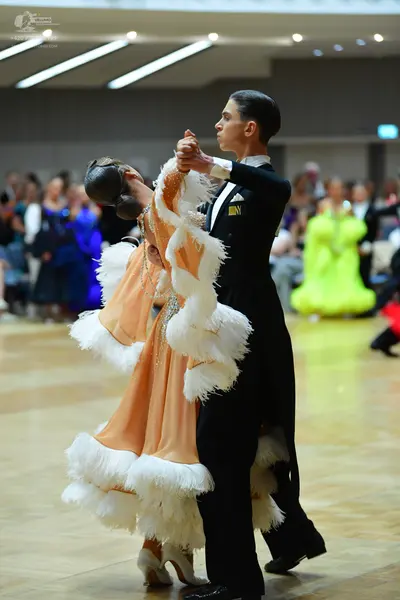 Dancesport competitor: Male dancer: black suit with a white shirt and white bow tie