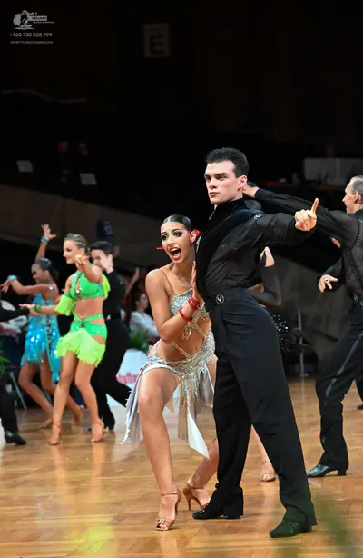 Dancesport competitor: Male dancer: black long-sleeved shirt and black trousers