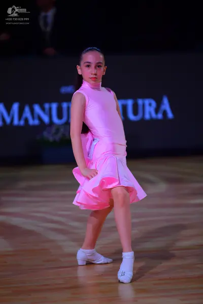 Dancesport competitor: Female dancer: pink satin latin dress with a high neck and a flared skirt
