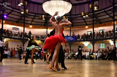 Dancesport competitor: Female dancer: red Latin dress with fringe and sequin bodice