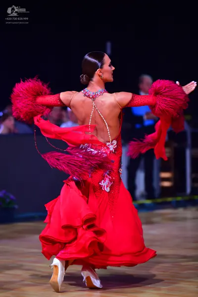 Dancesport competitor: Female dancer: red ballroom dress with silver/white sequin embellishments and la