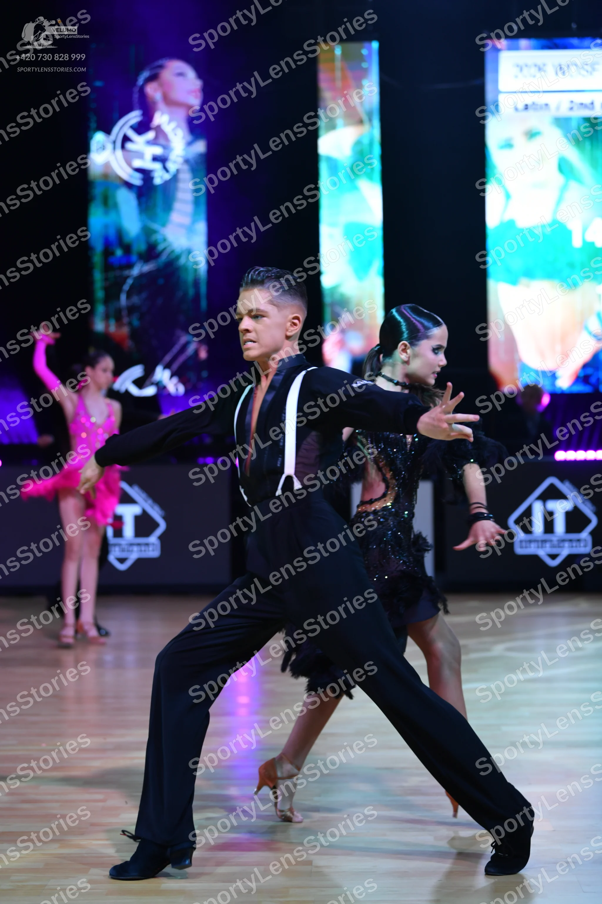Dancesport competitor: Male dancer: black long-sleeve shirt with white suspenders and black trousers